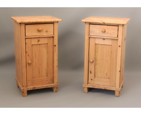 A pair of waxed pine bedside cabinets - single drawer over a panelled door enclosing a single shelf, raised on block feet. (L