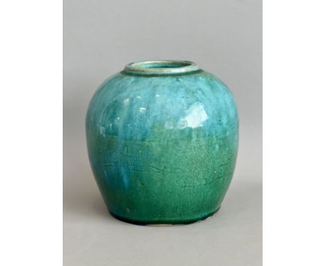 A Chinese shiwan glaze jar, possibly late-Ming period, c.1600 - of ovoid form, with the green glaze streaked with turquoise t