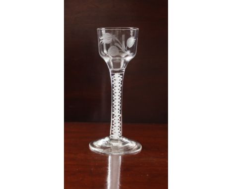 A mid-18th century opaque twist engraved wine glass, possibly Jacobite - circa 1765, the ogee bowl engraved with a rose bud s