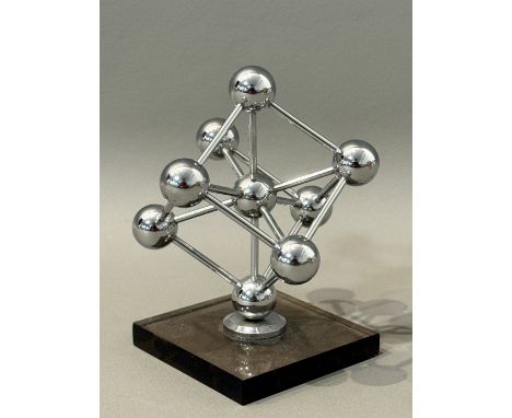 A 1958 World's Fair Atomium souvenir sculpture paperweight - the chrome plated replica of the Atomium landmark on a smoked ac