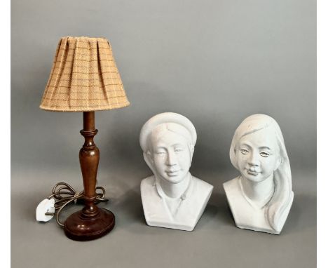 Two white glazed earthenware busts of young women - probably 1980s, 27cm high; together with a turned wooden table lamp with 
