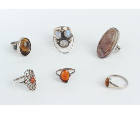 Six sterling silver vintage and modern gemstone set rings - including agate; carnelian; tiger's eye; and amber.