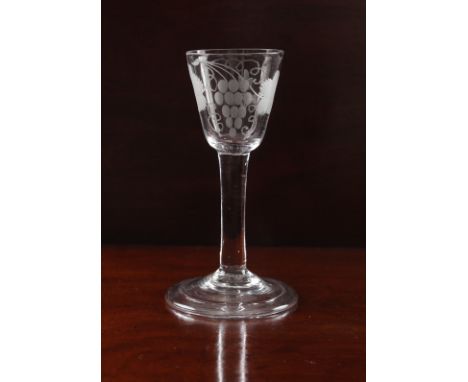 A mid-18th century engraved wine glass - circa 1745, the round funnel bowl engraved with a fruiting vine and floral sprig, on