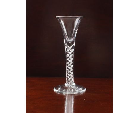 A mid-18th century mercurial airtwist tall wine glass - circa 1750, the drawn trumpet bowl on a mercurial airtwist stem on a 