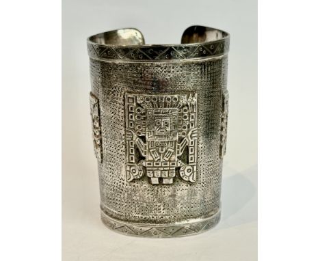 A Peruvian sterling silver cuff bangle - stamped 'Industria Peruana 925', decorated with sun god style motifs on a punch deco