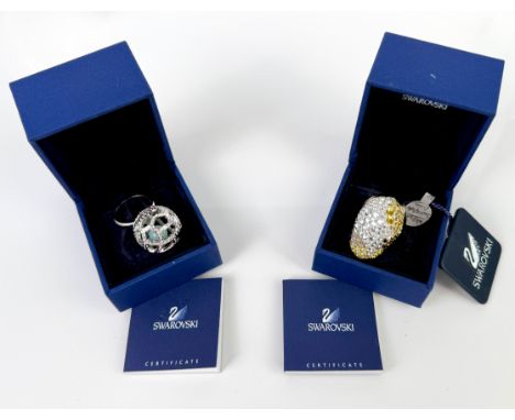 Two boxed Swarovski crystal dress rings - comprising a 935942 ring, pav&eacute; set with multi coloured gold, yellow, white a