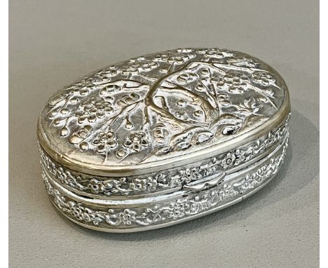 A Chinese silver oval box - early 20th century, maker's mark possibly Luen Wo, with repouss&eacute; and chased decoration of 