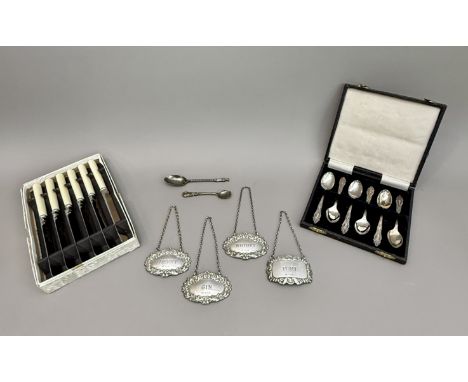 Four Elizabeth II silver wine labels - comprising a set of three of oval cartouche form, A Chick &amp; Sons Ltd, London 1976 