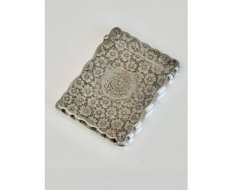 A late-Victorian silver card case - William M. Hayes, Birmingham 1900, rectangular with shaped borders, chased throughout wit