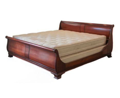 An Emperor size cherrywood sleigh bed - comprising a headboard and footboard, side rails with fixings (no slats or bed base i