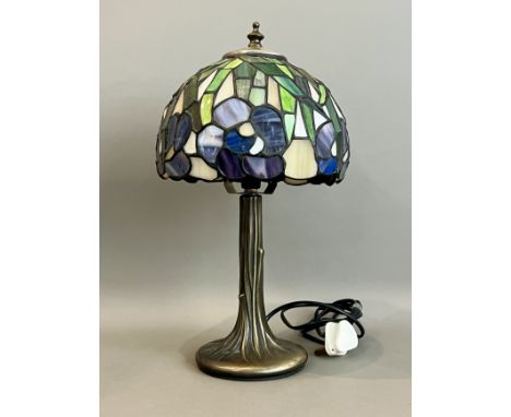 A Tiffany style stained glass table lamp - late 20th century, in the form of a tree, the bronzed metal, trunk-style base bene