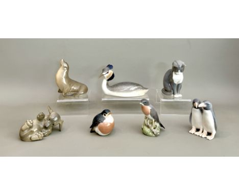 Six Royal Copenhagen figures - comprising a Crested Grebe, no. 3263; a Sealion, no. 1441; a pair of penguins no. 1190; a Dach