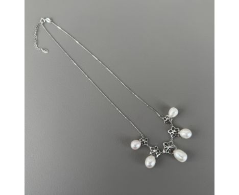 An 18ct white gold, pearl and diamond necklace by Fei Liu of Birmingham - stamped '750', with five pierced floral links set w