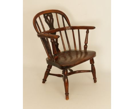 A scarce mid-19th century yew, elm and fruitwood child's Windsor chair - with pierced two-part splat and saddle seat, the tur
