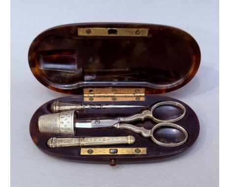 A 19th century French tortoiseshell cased sewing necessaire - of elongated oval form, enclosing a full compliment of sewing r