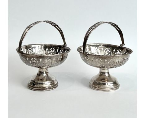 A pair of George V silver swing-handled bon-bon dishes - Duncan &amp; Scobbie, Birmingham 1923, with pierced decoration and b