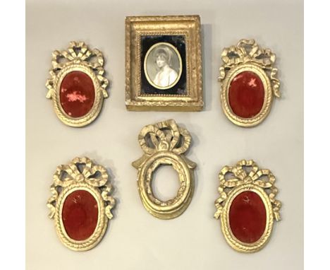 Five early 19th century portrait miniature frames - comprising a set of four with rope twist decorated oval frames below bold