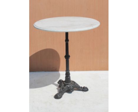 A marble-topped garden table - the circular top supported by a black-painted cast-metal column and tripod feet, 62 cm diamete