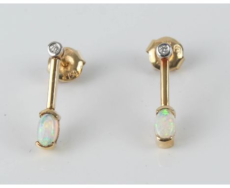 A pair of 18ct yellow gold, opal and diamond drop earrings - stamped '18K 750', the oval cabochon opals on a knife blade drop