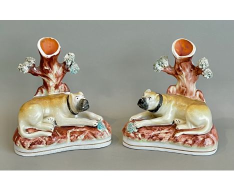 A pair of scarce 19th century Staffordshire bull mastiff spill vases - 15.5cm high, chip to ear on one dog.* Small chip to ti