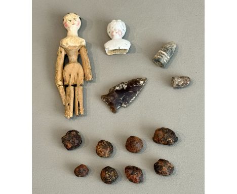 A small group of curios - including a napped flint arrowhead, possibly Neolithic, 3.8cm long; eight unusual iron-based metal 
