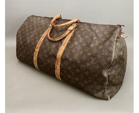 A vintage Louis Vuitton monogrammed canvas holdall bag - with tan leather handles and trim, approx. 60cm long, some wear, old