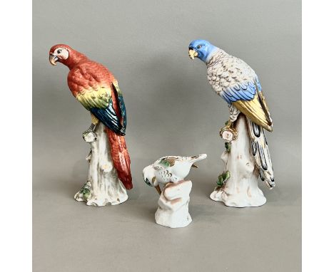 Two porcelain figures of parrots in the Meissen style by Samson of Paris - both perched on a tree stump, one in blue and gilt
