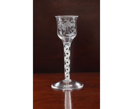 A mid-18th century engraved opaque twist wine glass, possibly Jacobite - circa 1765, the lipped, elongated ogee bowl engraved