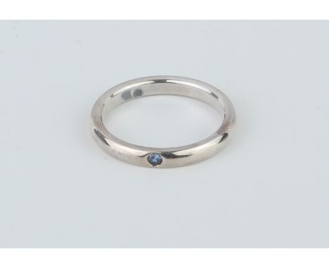 A Tiffany &amp; Co. 'Peretti' sterling silver ring - the rounded band inset with a single round cut pale blue stone, impresse