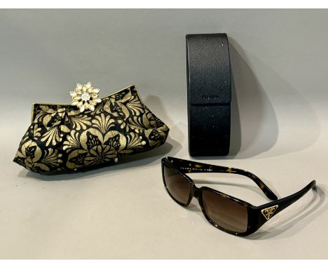 A pair of Prada faux-tortoiseshell sunglasses - ref. SPR 16L, in the original case. (slight scratching to one lens); together
