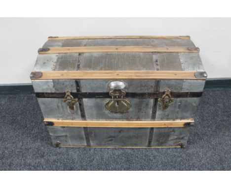 An early 20th century metal wooden bound trunk 