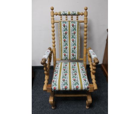 A blonde oak tapestry upholstered rocking chair 