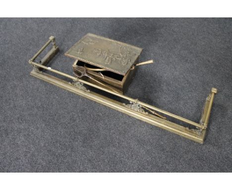 A Victorian brass fire curb, brass embossed slipper box containing fire poker, toasting horn and hunting horn 