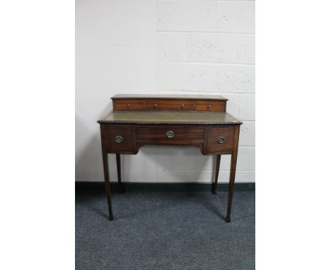 A mahogany Regency style writing desk with green leather inset panel 