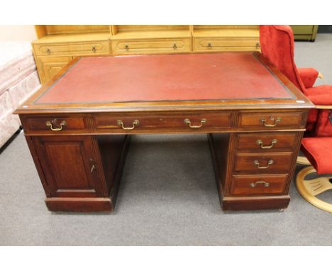 An Edwardian mahogany partner's desk with red leather inset panel 