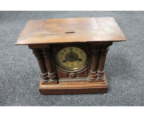 An Edwardian pine cased mantel clock with brass and enamelled dial 