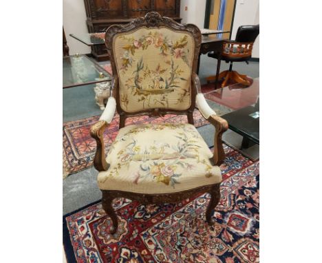 A continental walnut framed armchair in tapestry fabric, width 65 cm 