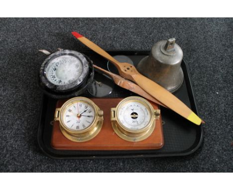 A tray of ship's compass, ship's bell, brass cased barometer and clock mounted on board, two wooden model plane propellers  