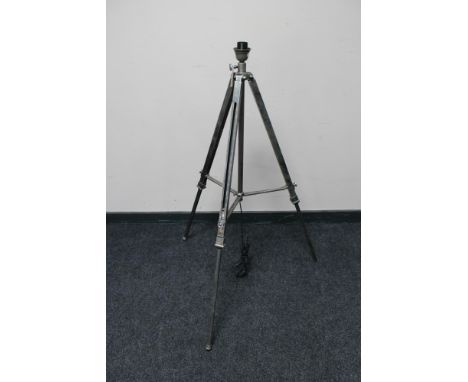 A contemporary metal tripod standard lamp base