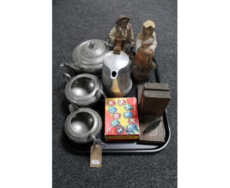 A tray of pair of pottery figures, wooden bookends, three piece English pewter tea service and a Picquot ware teapot 
