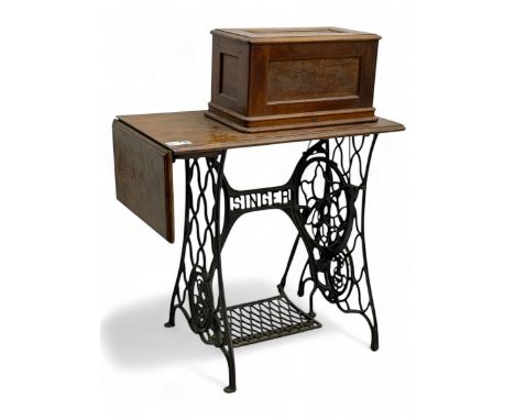 Singer - early 20th century cast iron treadle sewing machine, with hand crank wheel and oak work surface, the machine decorat