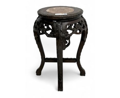 Early 20th century Chinese hardwood jardinière stand, circular pink marble inset top above a pierced and carved frieze of pru