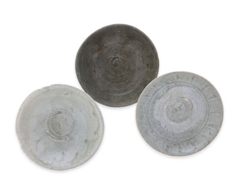 A GROUP OF THREE GLAZED STONEWARE BOWLS
14th-16th Century, a Vietnamese shallow dish with incised vertical lines and kiln sta