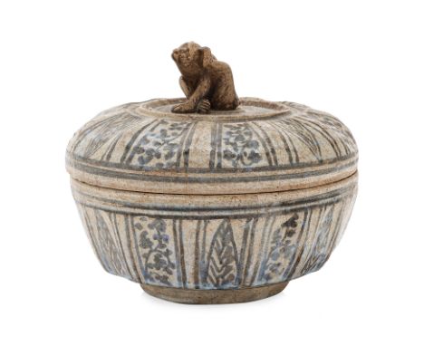 A THAI BOX AND COVER WITH MONKEY FINIAL
Sawankhalok, 15th Century, circular box with fluted sides, decorated in alternating b