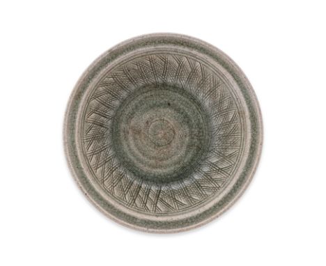 A THAI CELADON BOWL
Sawankhalok, 15th Century, a pale green glazed shallow bowl, incised trellis to inner walls, ring to cent