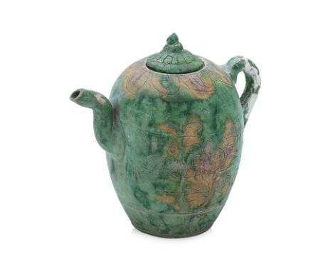AN INCISED SANCAI GLAZED EWER AND COVER
Liao Dynasty or later, ovoid form with a thick strap handle, curled spout and small b