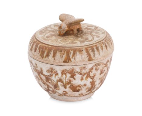 A THAI BOX AND COVER WITH BIRD FINIAL
Sawankhalok, 15th Century, circular box and cover decorated with incised foliage, pale 