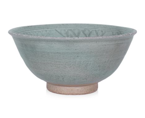 A THAI COMBED CELADON DEEP BOWL
Sawankhalok, 15th Century, the interior with incised underglaze floret, larger lotus form pet