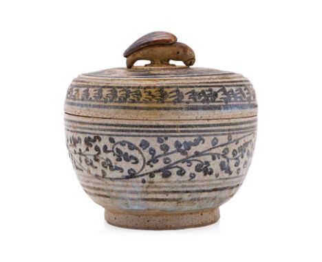 A THAI BOX AND COVER WITH BIRD FINIAL
Sawakhalok, 15th Century, circular box and cover decorated in underglaze brown foliage,