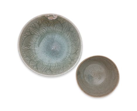 TWO THAI CELADON BOWLS
Sawankhalok, 14th-15th Century, a deep heavily potted bowl with rounded sides, incised underglaze peta